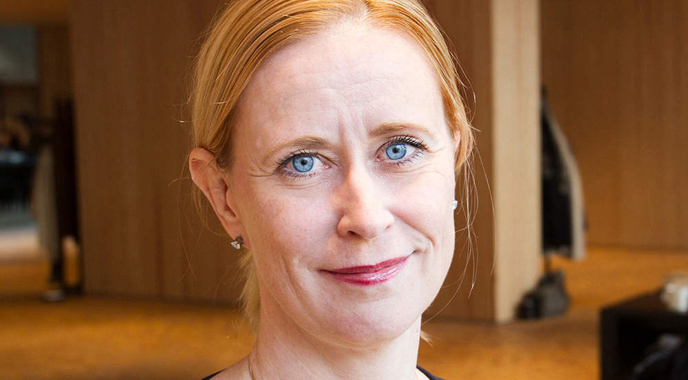 Rödhåriga Erika Läfström i en lobbymiljö.